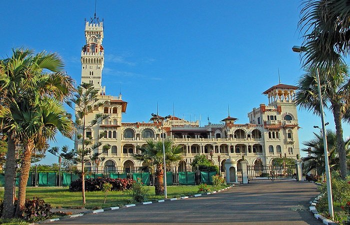 Montazah Palace surrounded by lush gardens and overlooking the Mediterranean Sea.